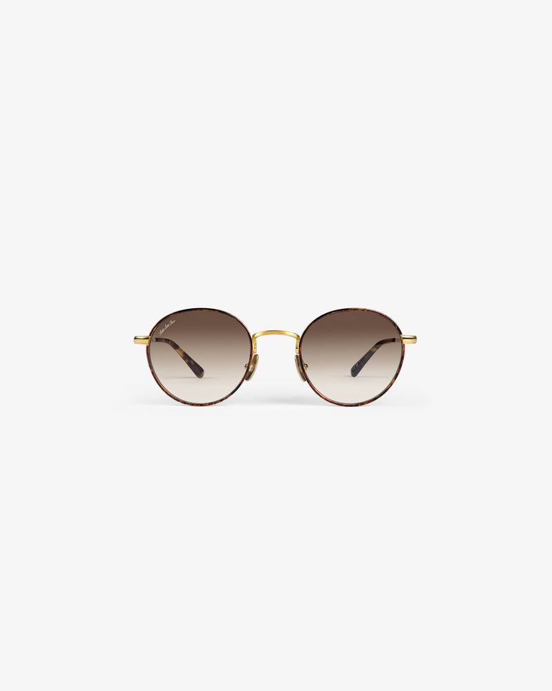 Giórgios Sunglasses: Round frames with brown gradient lenses, gold bridge, and thin gold arms on white background.