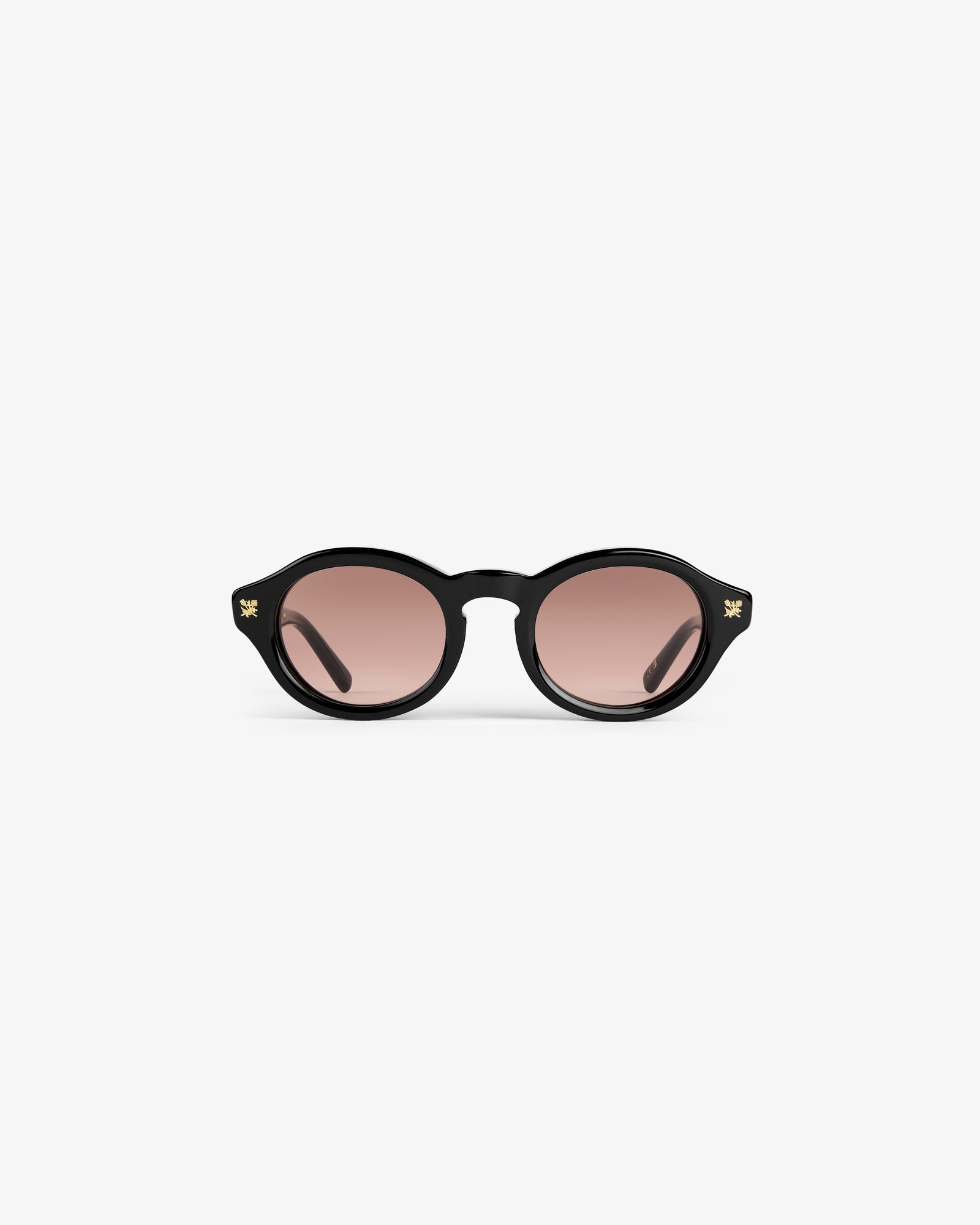 Onásis Sunglasses: black, round frames with pink tinted lenses, shown front-facing on a plain white background.