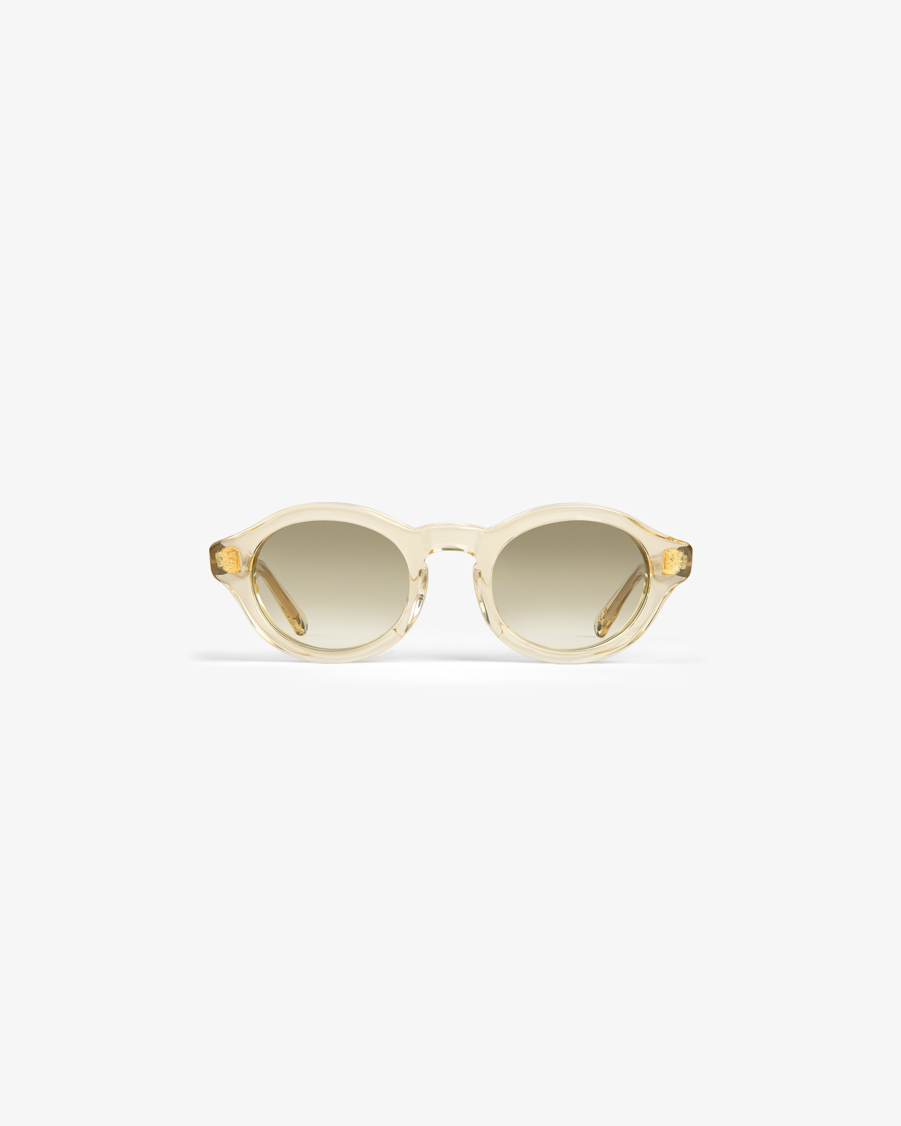 Onásis Sunglasses: round, translucent beige frames with light brown gradient lenses, shown on a white background.
