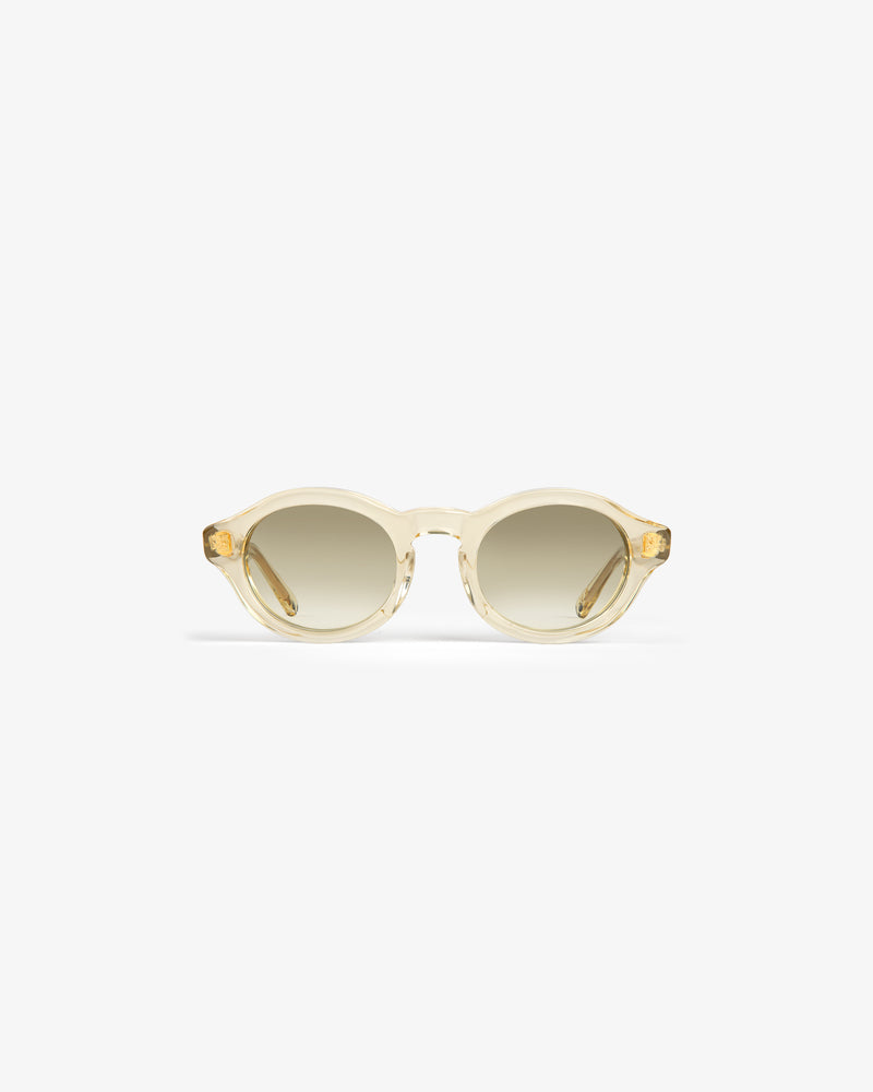 Onásis Sunglasses: round, translucent beige frames with light brown gradient lenses, shown on a white background.