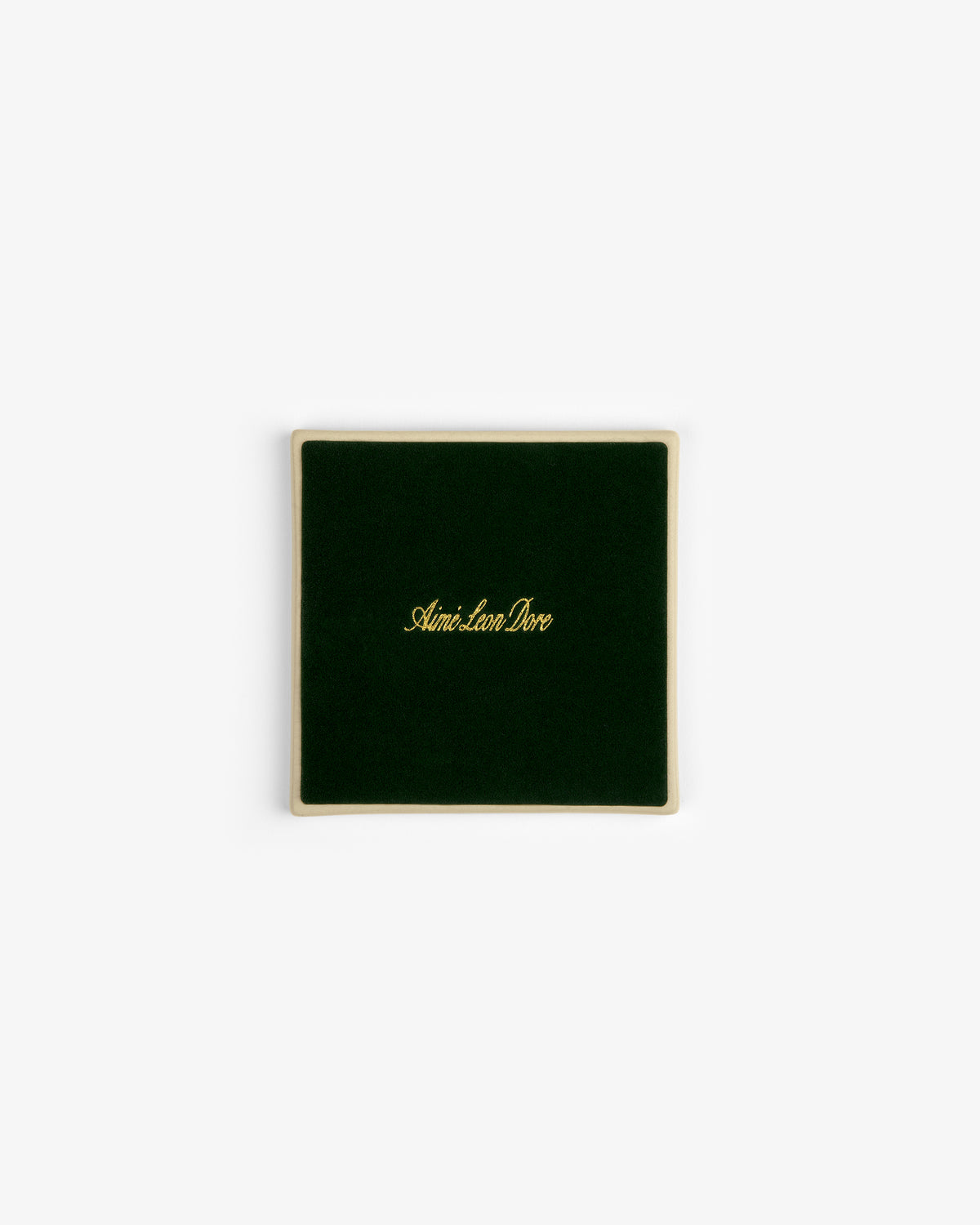 A set of four square green velvet Crest Coasters with gold Aimé Leon Dore text, shown on a white background.