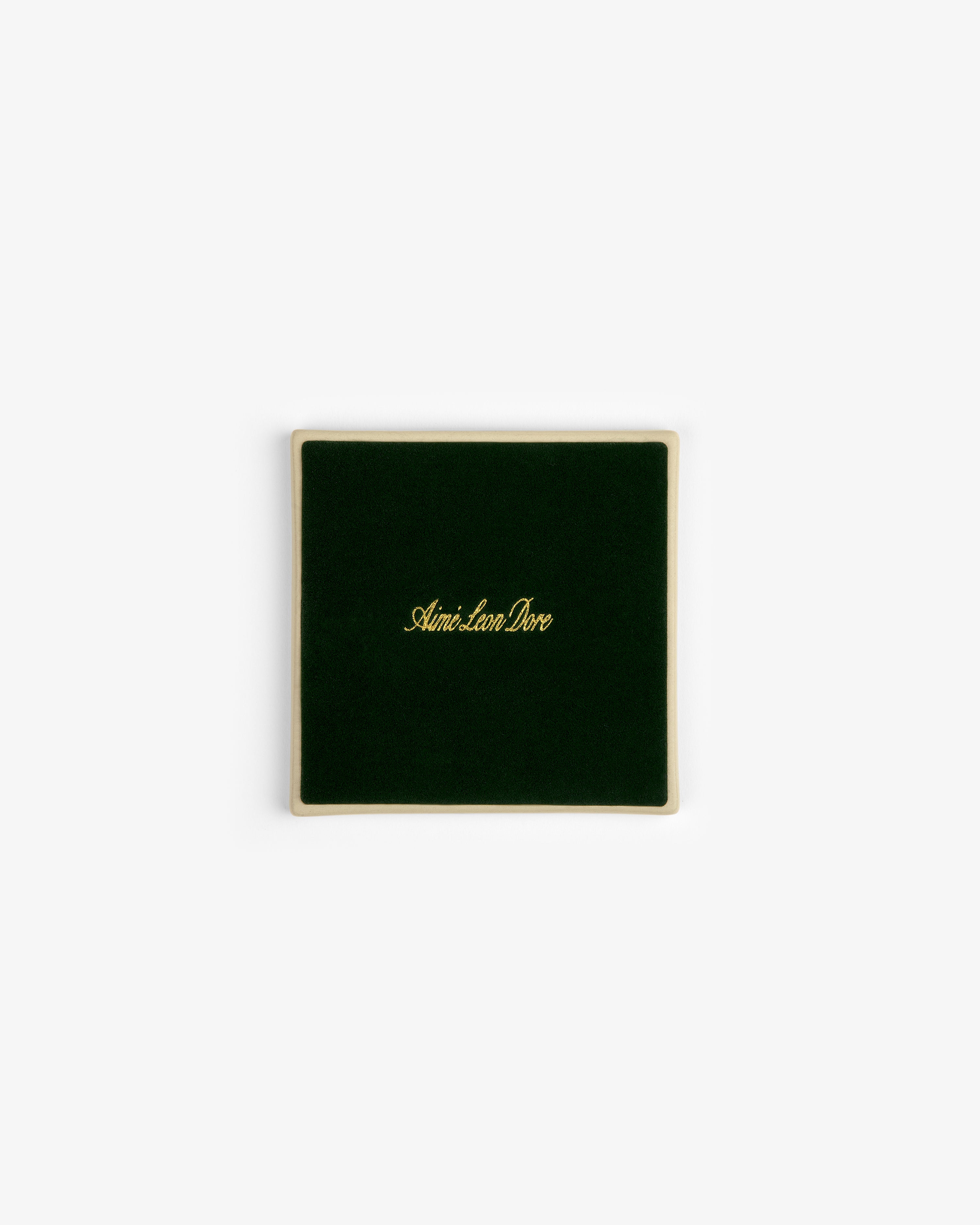 A set of four square green velvet Crest Coasters with gold Aimé Leon Dore text, shown on a white background.