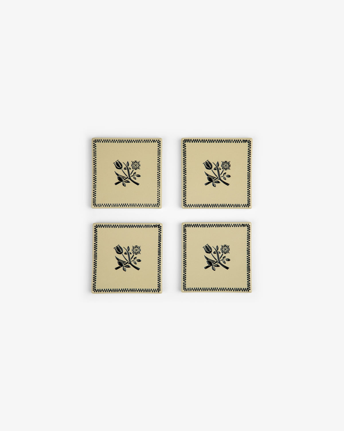 Crest Coaster (Set of 4): Beige coasters with black floral and zigzag designs, arranged in a two-by-two grid.