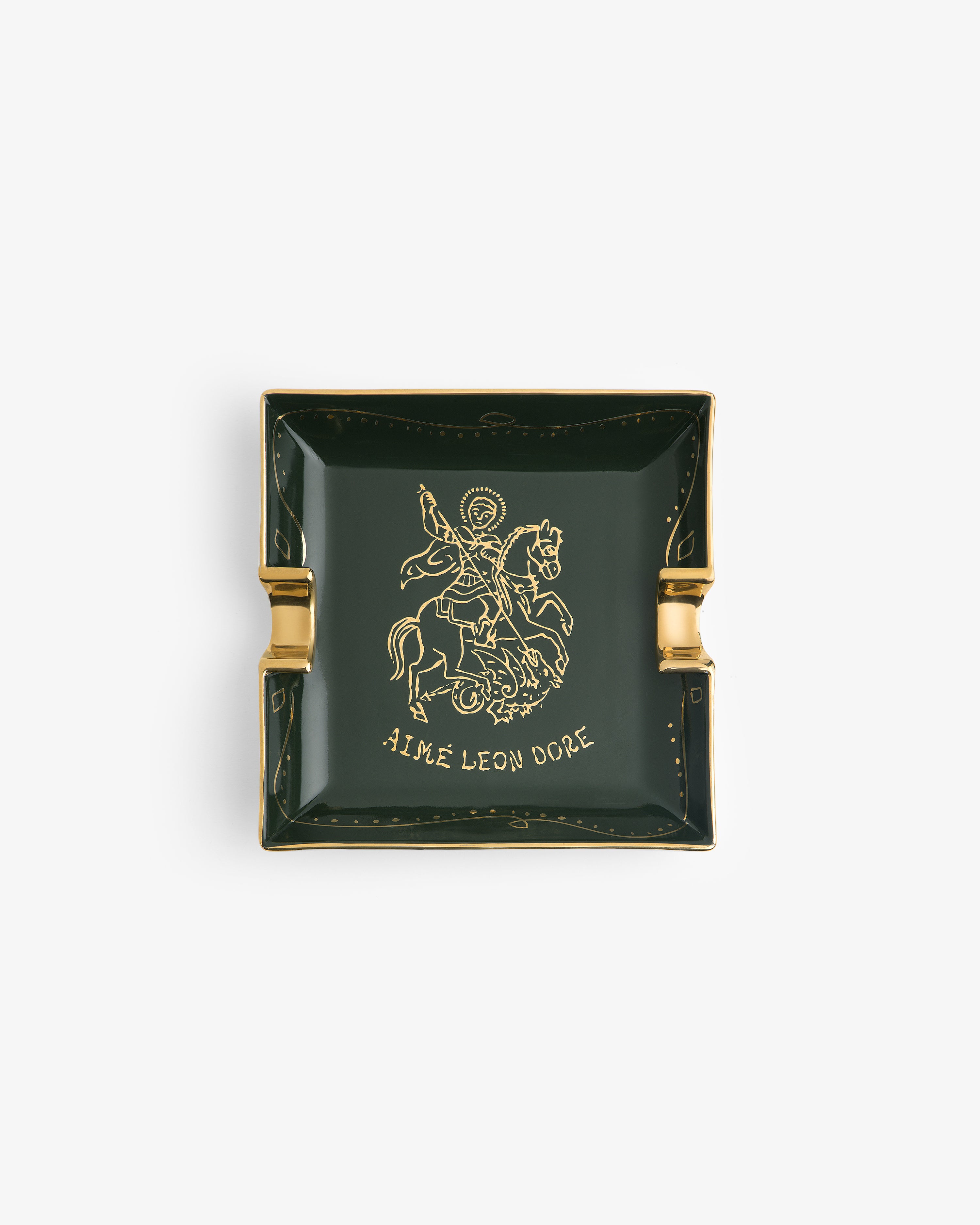 Dark green Saint George Ashtray with gold edges, horse rider drawing, and Aime Leon Dore label.
