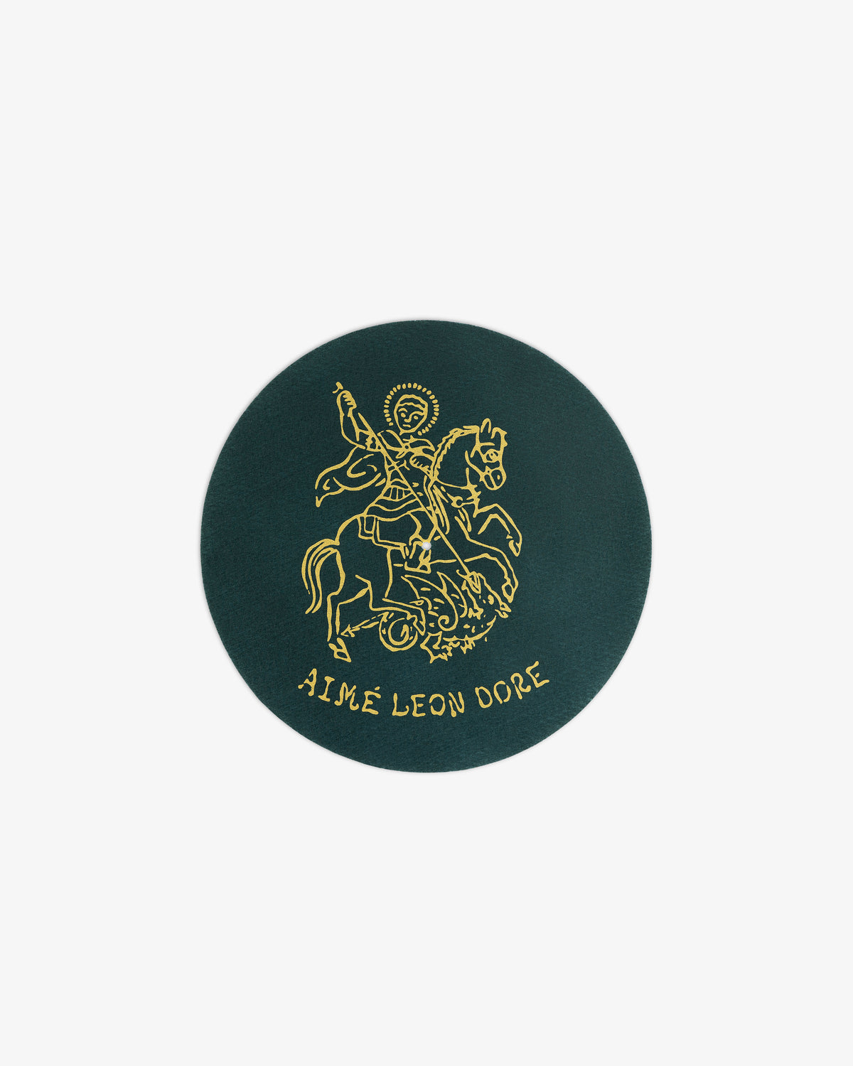 Dark green circular Graphic Slip Mats with a gold line drawing of a saint on horseback and AIMÉ LEON DORE below.