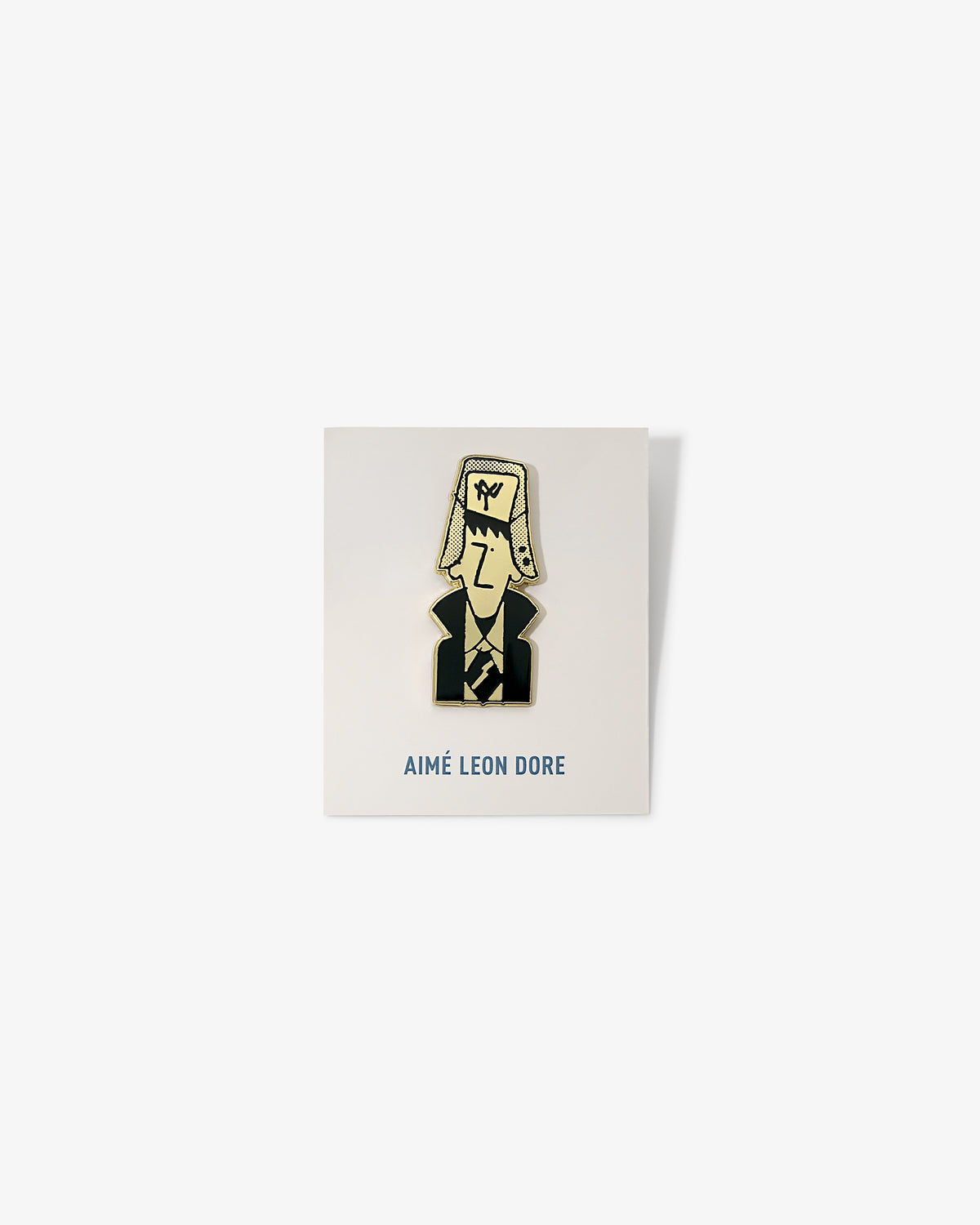 Graphic Pin featuring a cartoon man in a suit and large hat, on a white AIMÉ LEON DORE card.