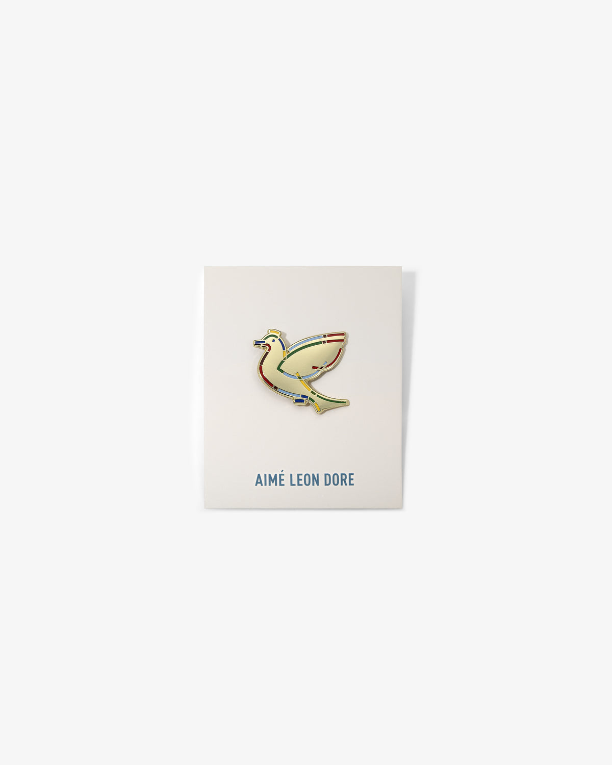Graphic Pin featuring a yellow bird on a white card with AIMÉ LEON DORE in blue at the bottom.