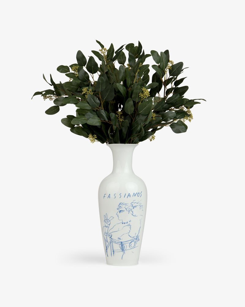 Fassianos "Rendez - Vouz" Vase with blue line art, holding leafy green branches and small white buds.