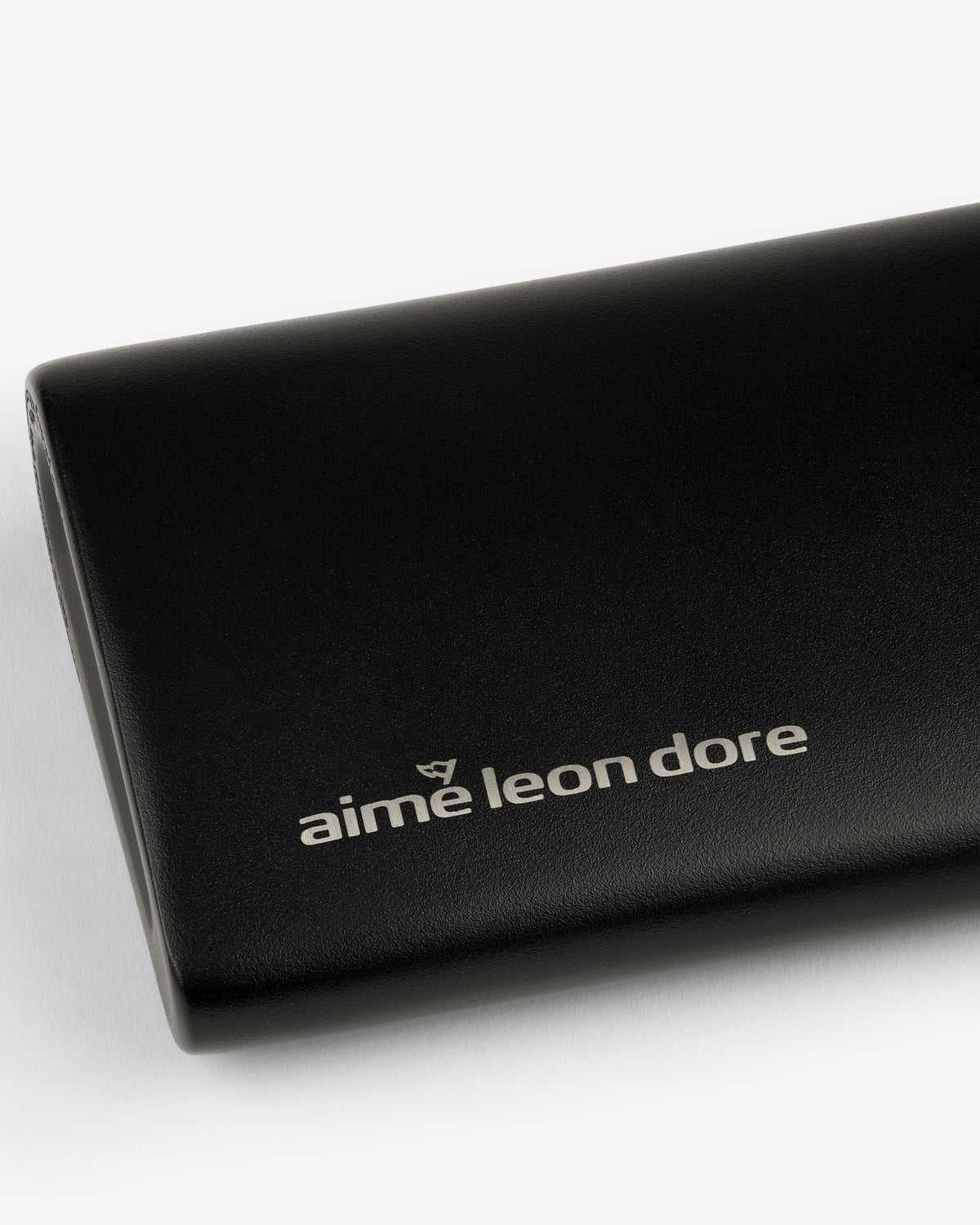 Black ALD Golf 19th Flask with "aime leon dore" in white lowercase on front, shown on a white background.