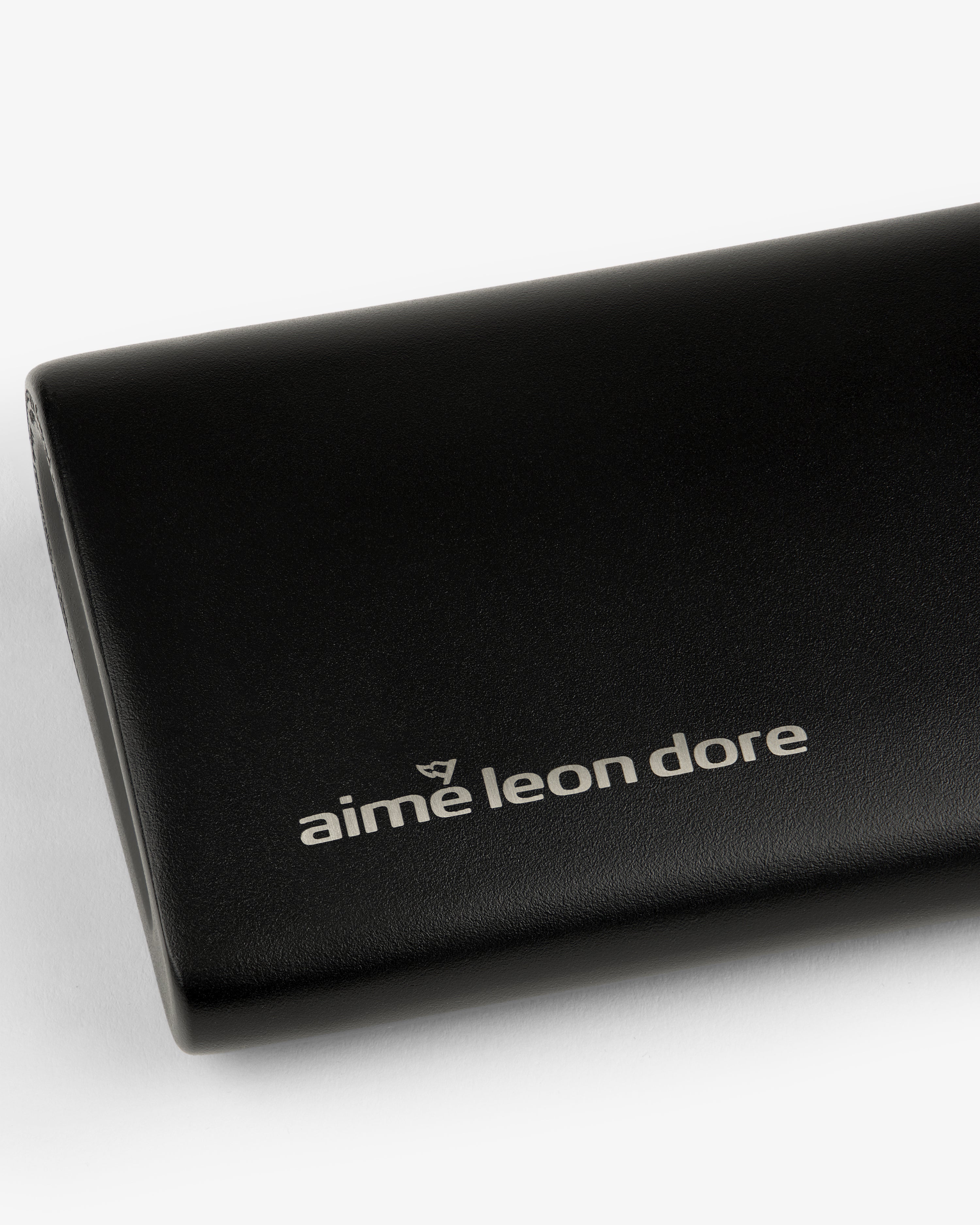 Black ALD Golf 19th Flask with "aime leon dore" in white lowercase on front, shown on a white background.