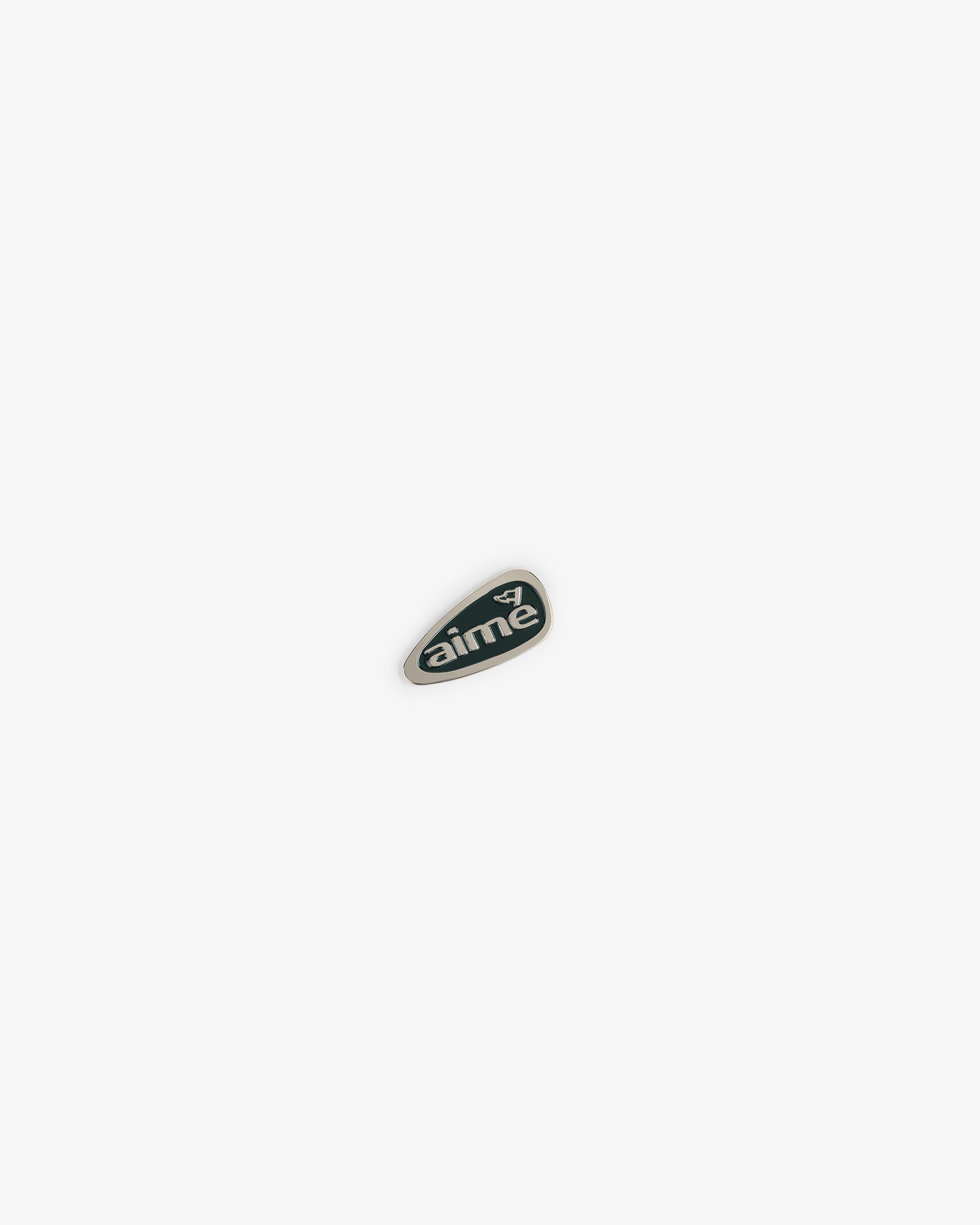 A small green ALD Golf Divot Tool with "aime" and a white bird logo on a plain white background.