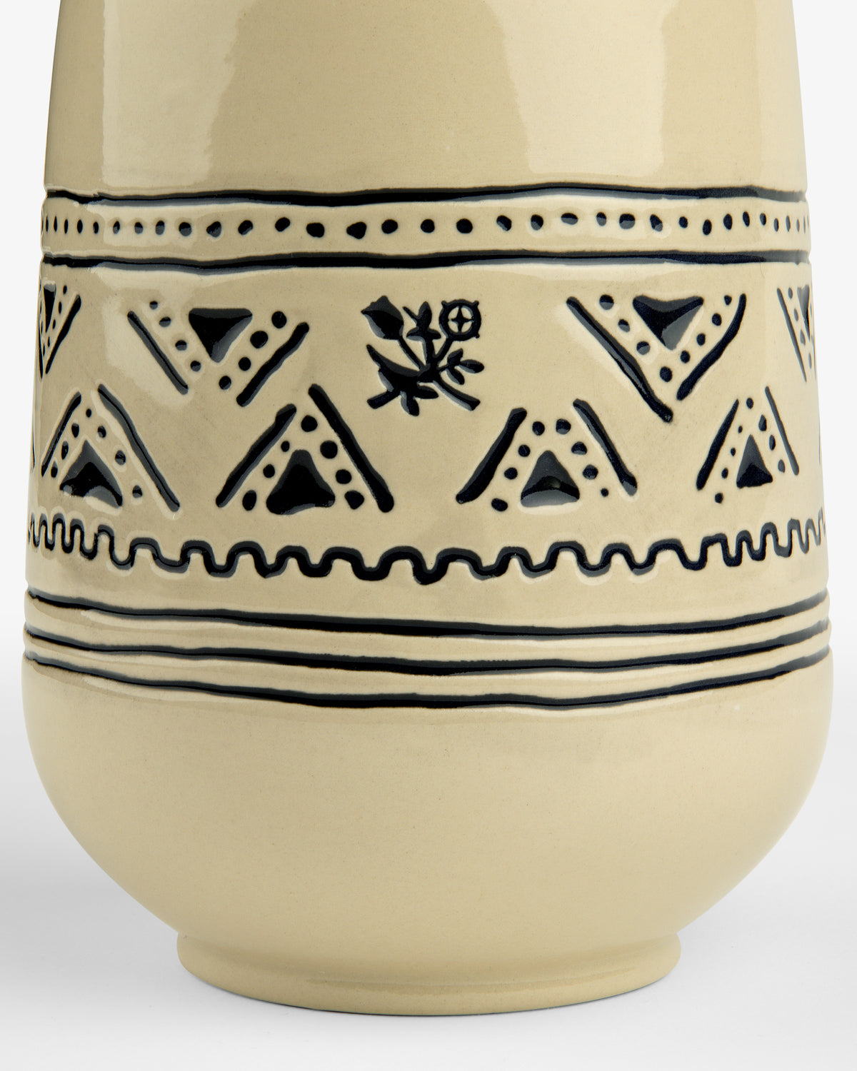 Close-up of the Textile Patterned Vase featuring beige ceramic and black geometric designs with a central floral motif.
