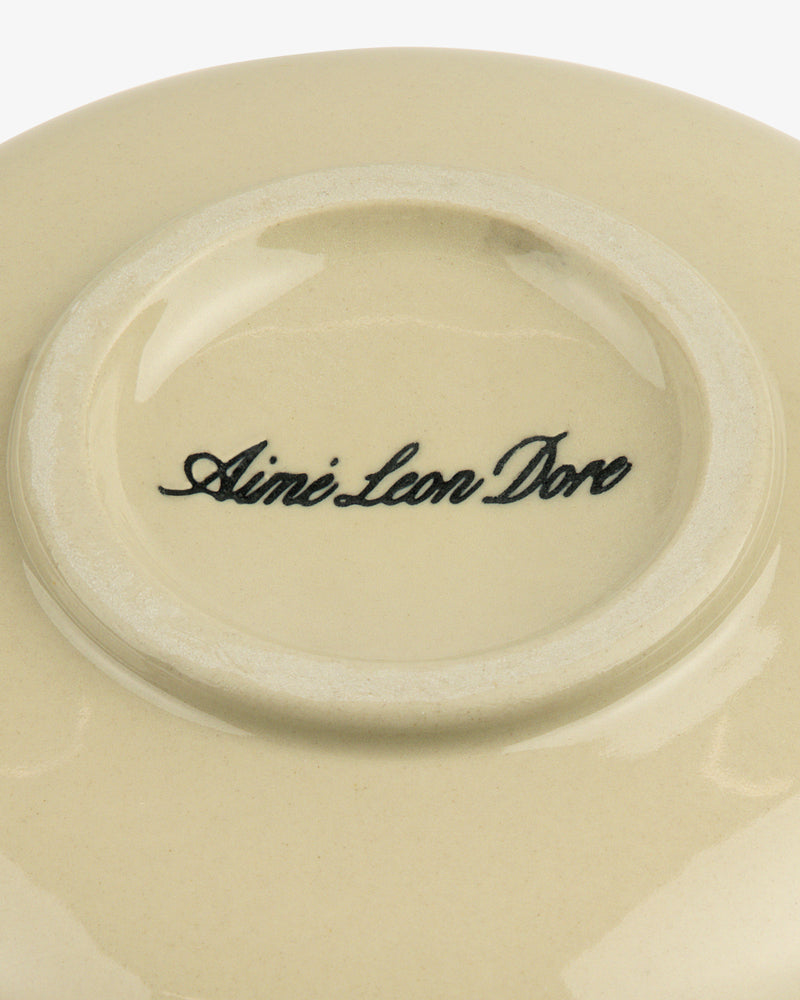 Textile Patterned Bud Vase base features Aime Leon Dore in black script at the center of beige ceramic.
