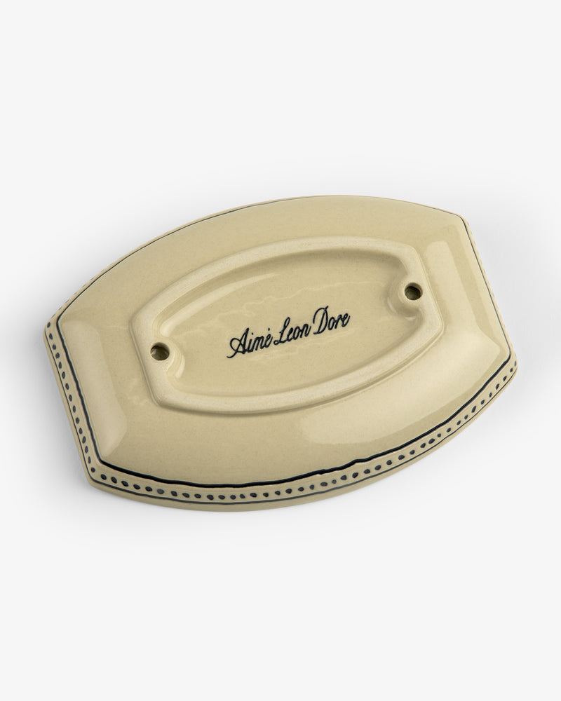 Beige ceramic Crest Catchall with Aimé Leon Dore script, bordered by dotted and solid black lines.