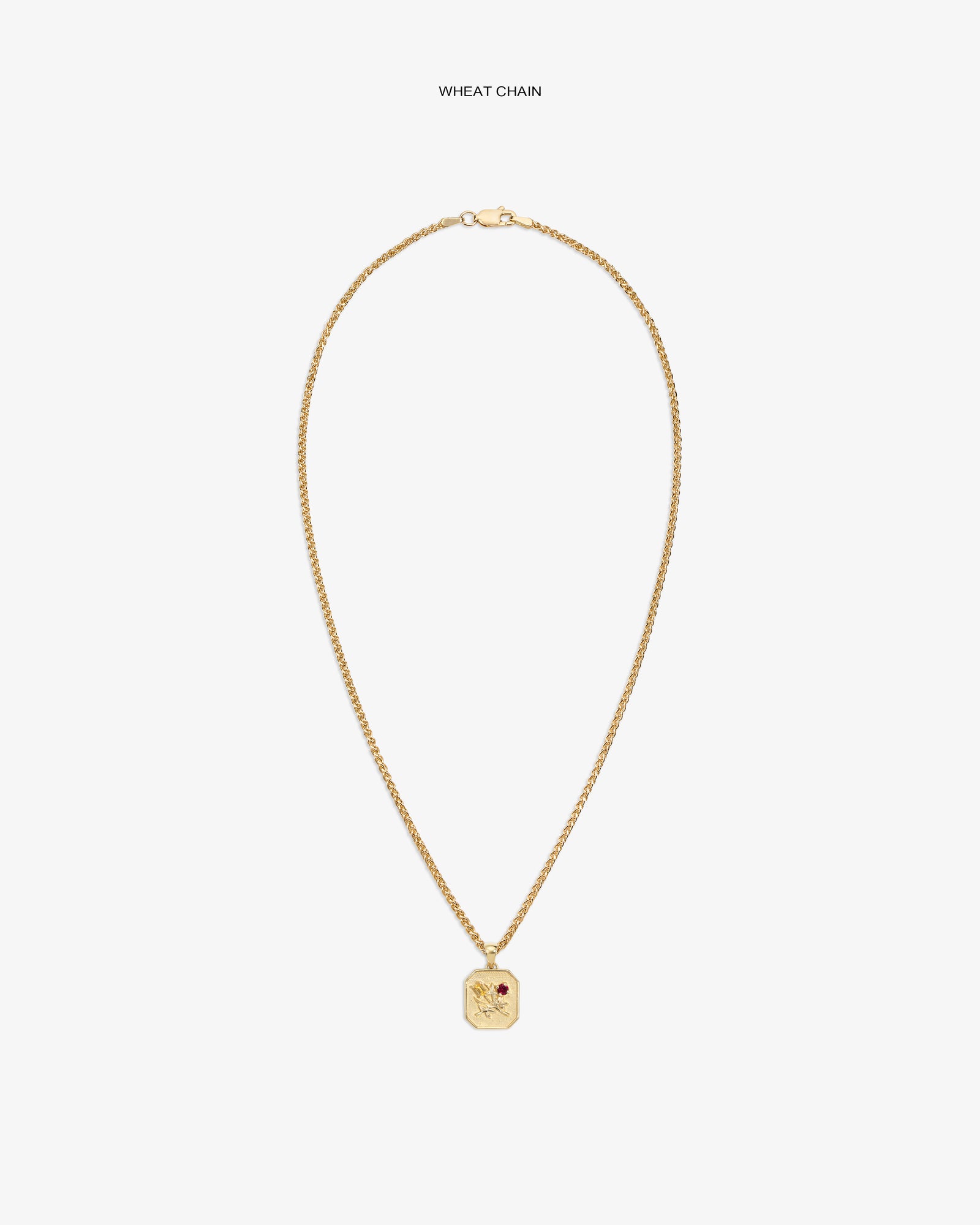 14Kt Gold Queens Crest Relief Pendant with wheat chain and red stone, displayed on a white background.