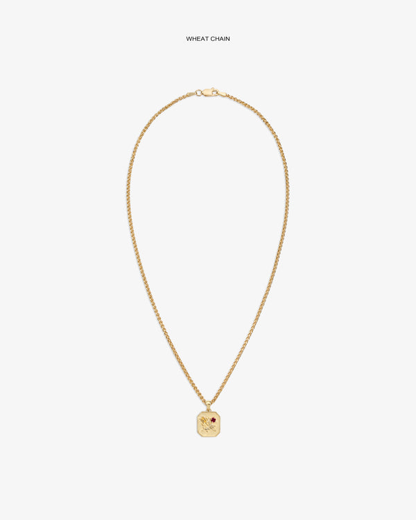 14Kt Gold Queens Crest Relief Pendant with wheat chain and red stone, displayed on a white background.