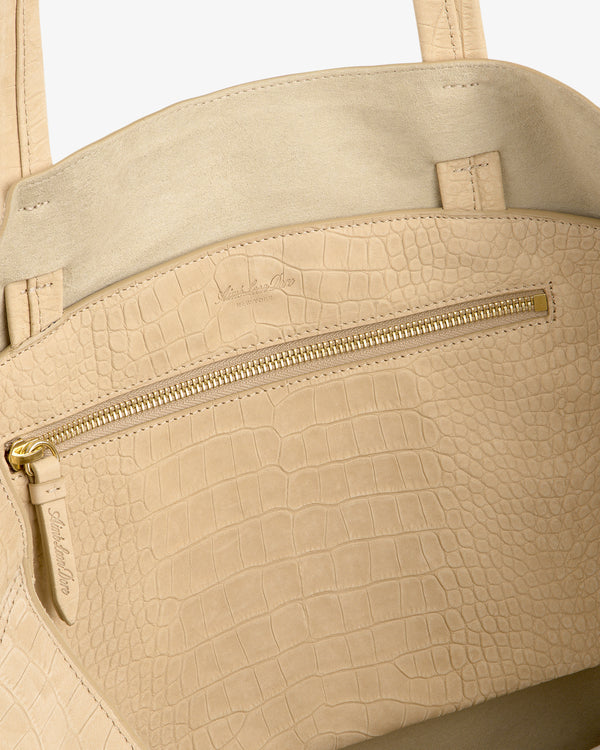 Close-up of the Croc-Embossed Nubuck Tote Bag featuring a gold zipper pocket and a soft suede interior.