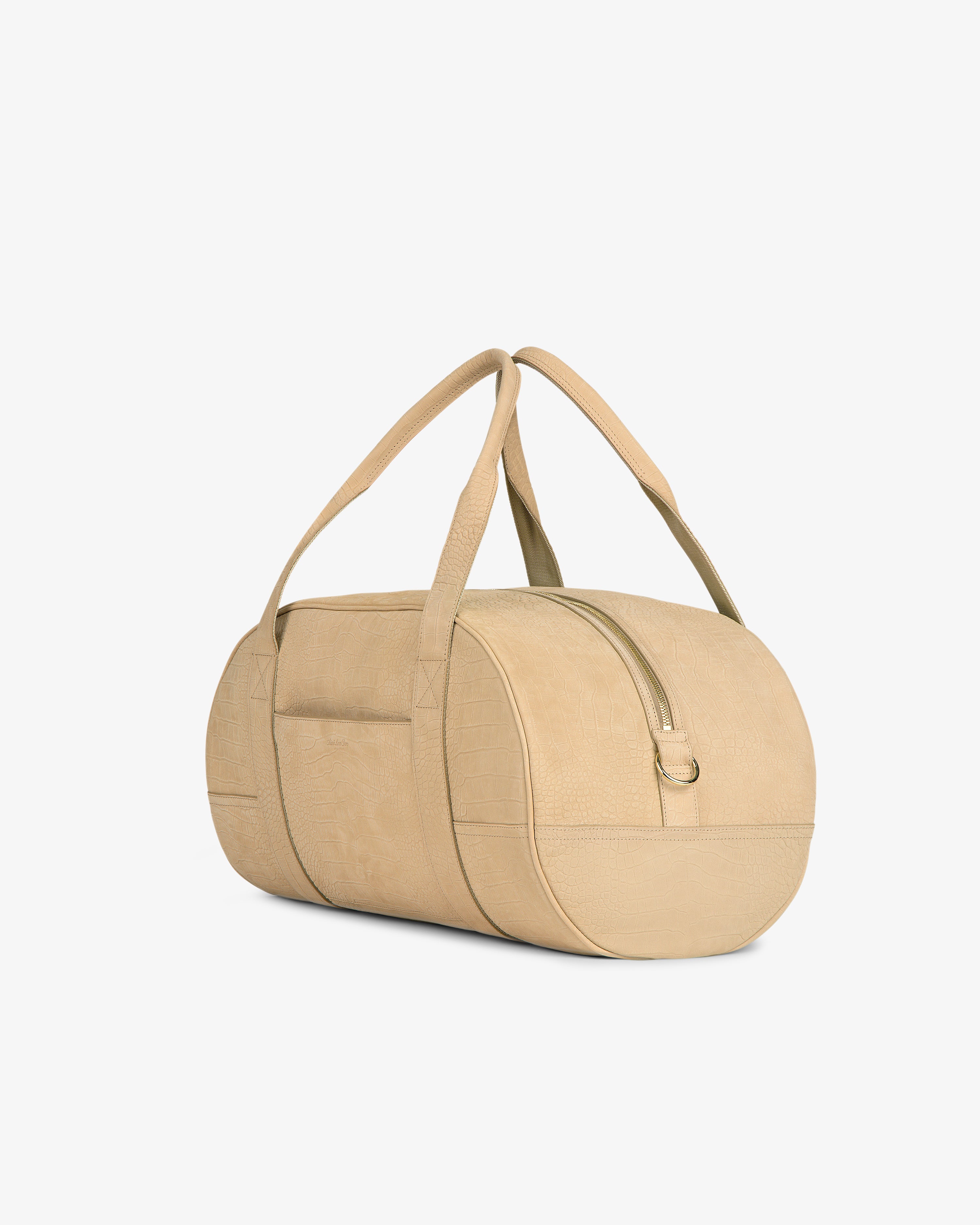 Croc-Embossed Nubuck Duffle, beige and cylindrical with long handles, side pocket, and top zipper on a white background.