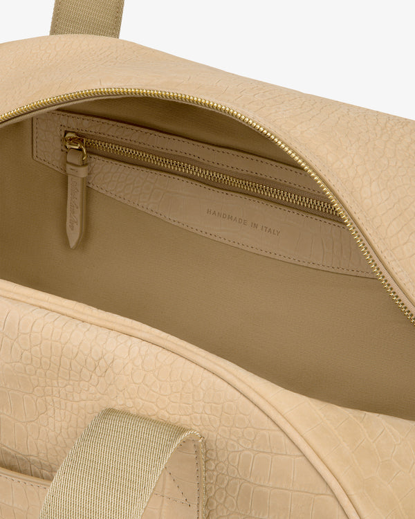 Croc-Embossed Nubuck Duffle with gold zipper, open to show inside pocket labeled “Handmade in Italy.”.