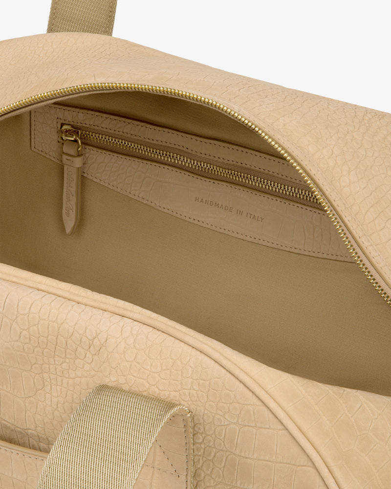 Croc-Embossed Nubuck Duffle with gold zipper, open to show inside pocket labeled “Handmade in Italy.”.