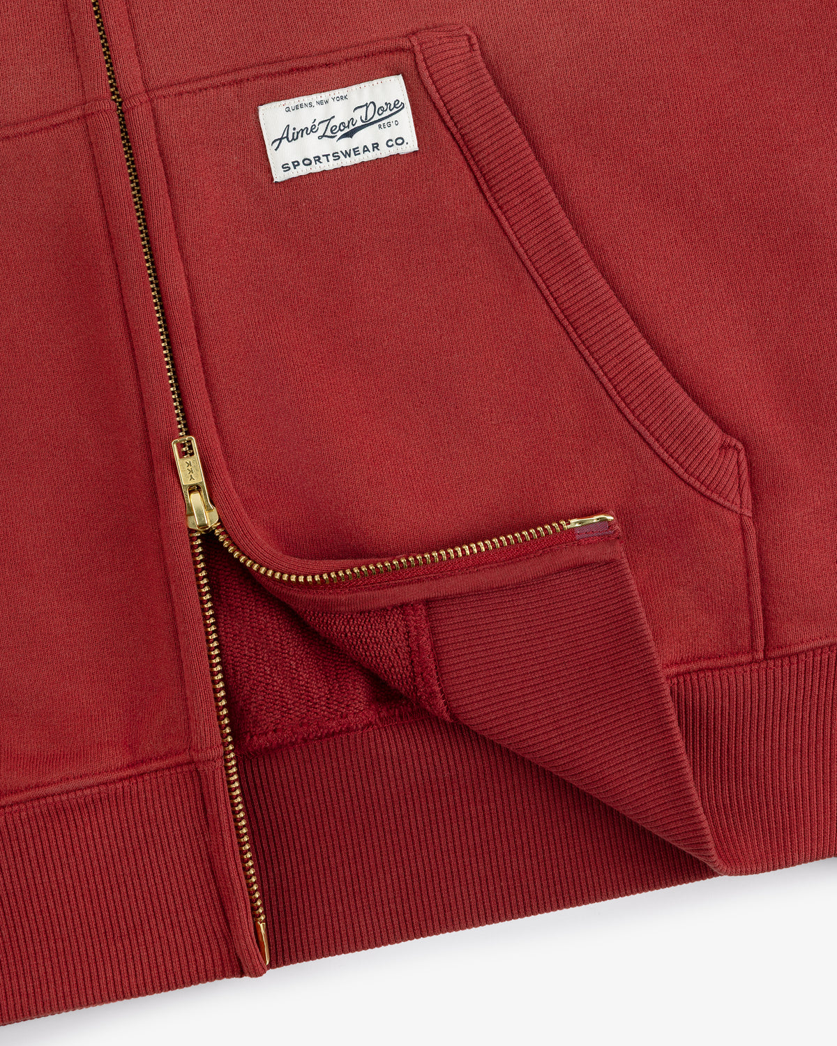 Sun Faded Full-Zip Hoodie in red with gold zipper, ribbed hem, front pocket, and white sportswear chest label.