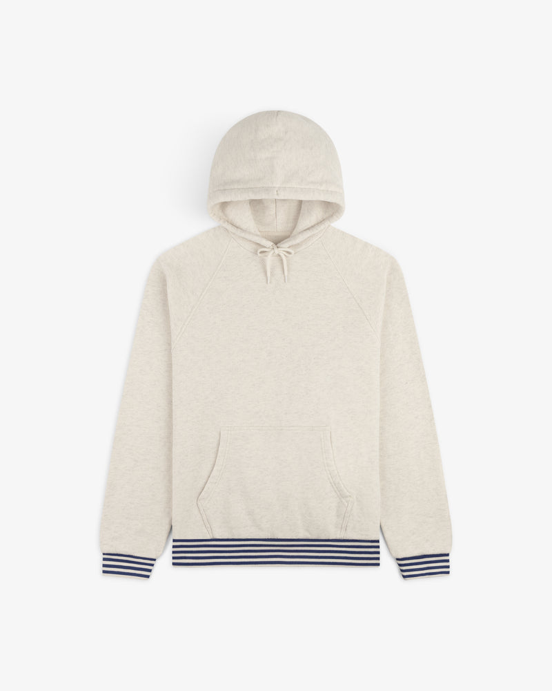 Dock Hoodie in light beige, featuring a front pocket and navy striped ribbed cuffs and waistband, laid flat on white.
