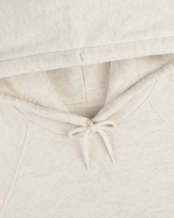 Close-up of the Dock Hoodie in light beige, featuring the hood, drawstring, and part of the neckline.