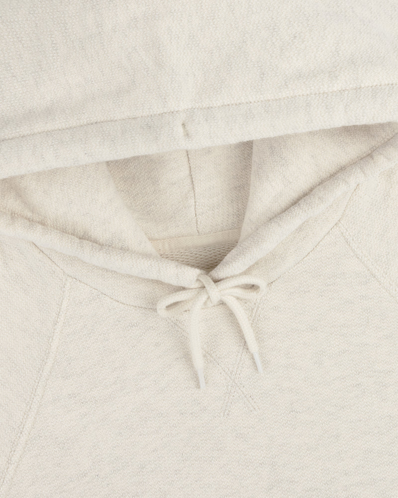 Close-up of the Dock Hoodie in light beige, featuring the hood, drawstring, and part of the neckline.