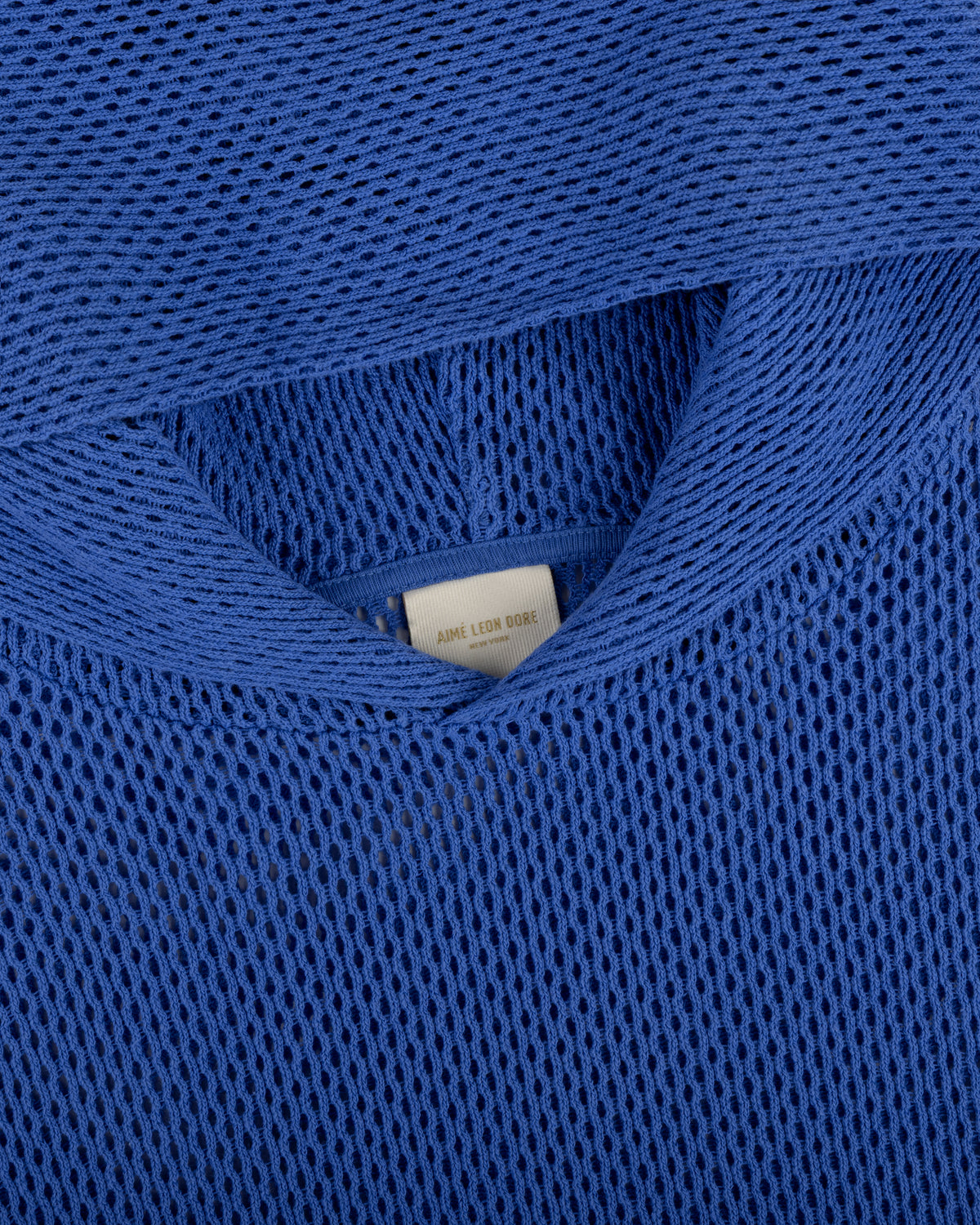 Close-up of a blue Open Mesh Hoodie highlighting the neckline and interior label detail.