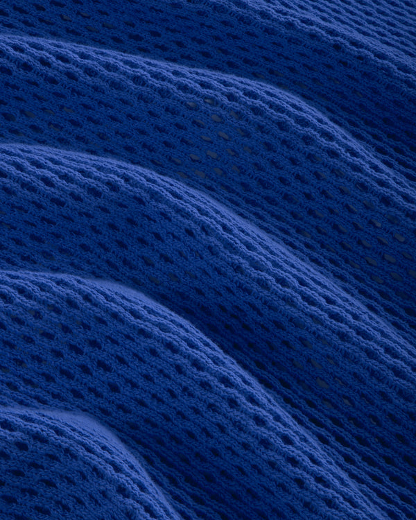 Close-up of the Open Mesh Hoodie in blue, featuring textured fabric with wavy folds and a mesh-like pattern.