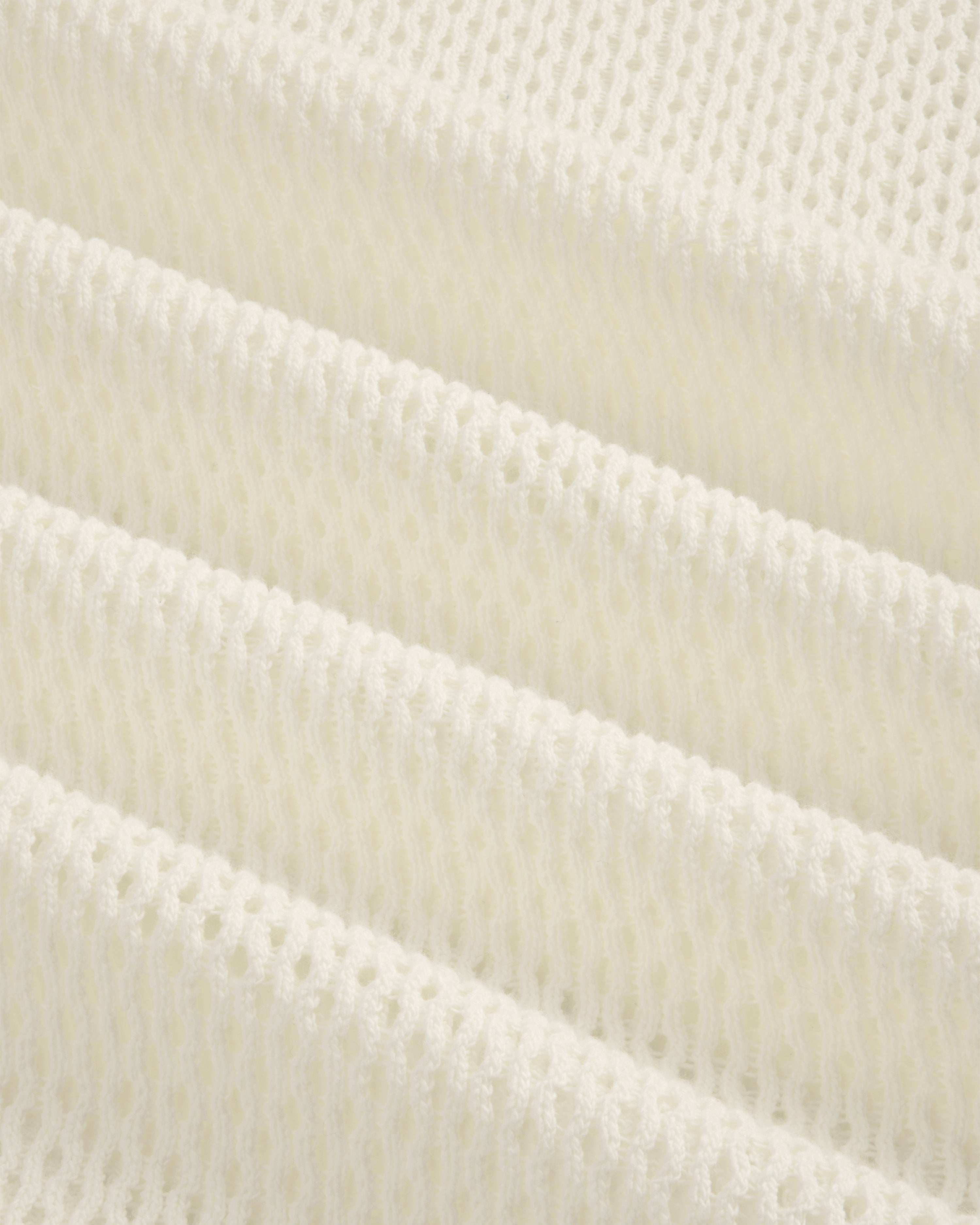 Close-up of the white Open Mesh Hoodie featuring a knitted, ribbed texture in horizontal folds.