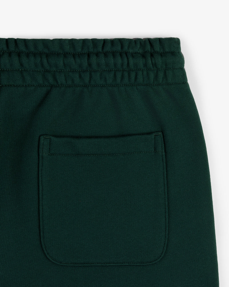 Close-up of Crest Sweatpants in dark green featuring an elastic waistband and a single back pocket.