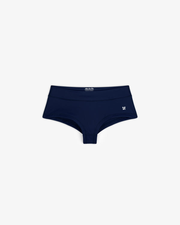 Navy Crest Swim Short for women with a small white butterfly logo on the left, shown on a white background.