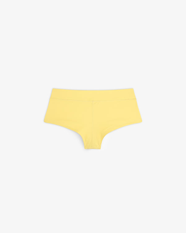 Crest Swim Short in yellow for women displayed on a white background.