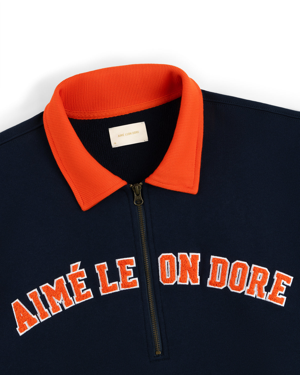 Collegiate Quarter Zip Pullover in navy with a red collar and AIMÉ LEON DORE in red and white across the chest.