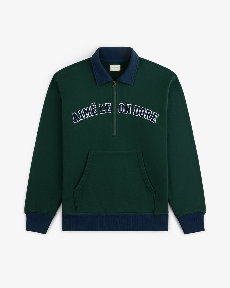 Collegiate Quarter Zip Pullover in dark green with navy collar and cuffs, AIMÉ LEON DORE embroidered on chest.