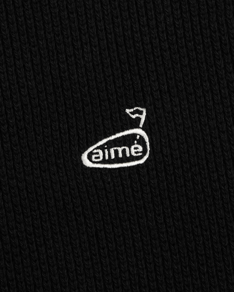 Black ribbed ALD Golf Piqué Full Zip Sweater with a small white aimé logo and stylized flag above the “e.”.