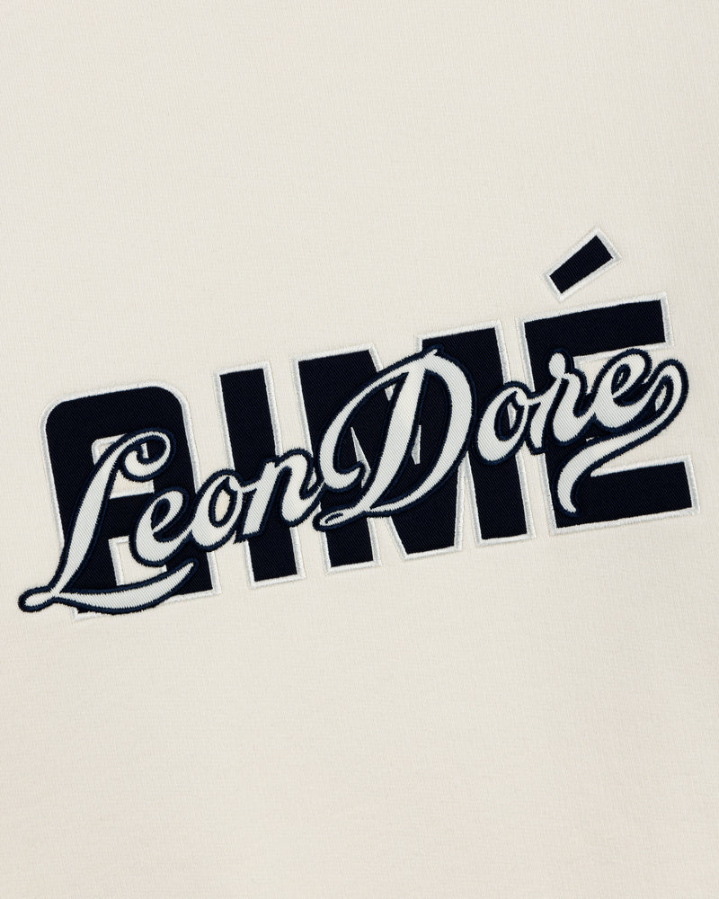 Cream-colored Overlay Logo Crewneck Sweatshirt with black and white "Aimé Leon Dore" embroidery.
