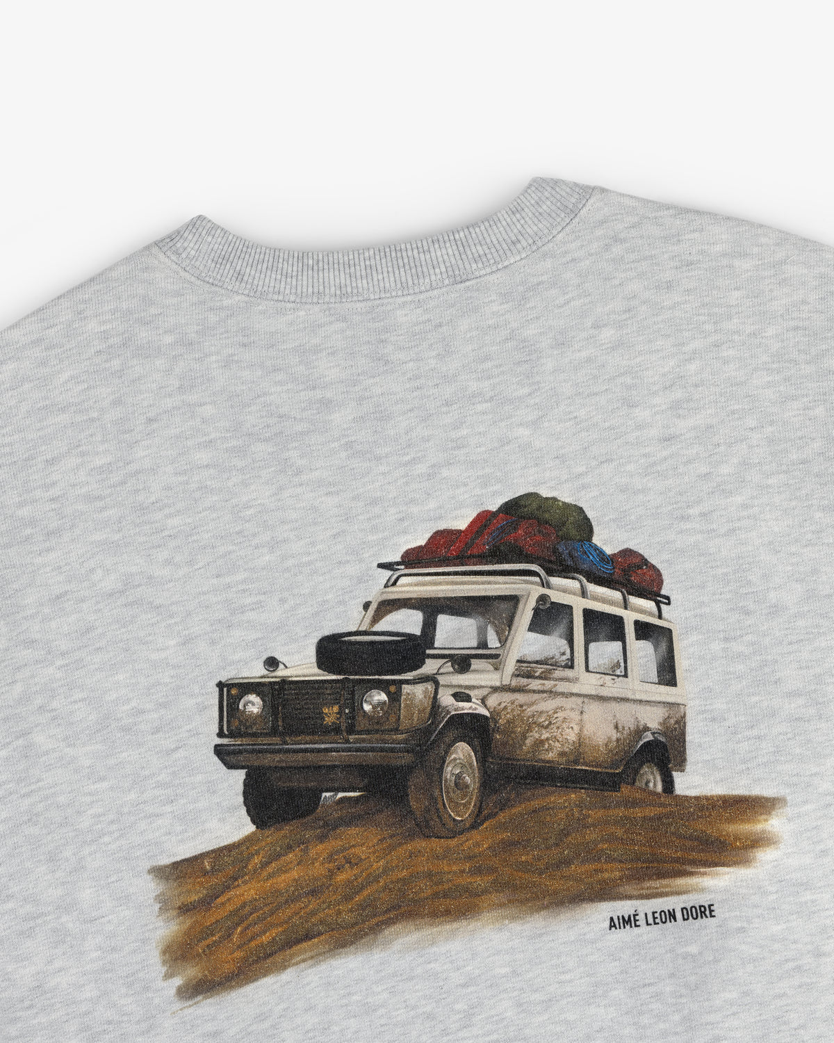 Illustration of a muddy SUV with luggage, printed on Safari Crewneck Sweatshirt with AIMÉ LEON DORE text below.