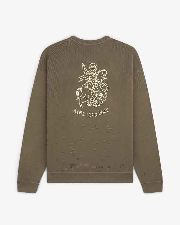 Olive green Saint George Piqué Crewneck with knight line drawing and AIMÉ LEON DORE text on the back.