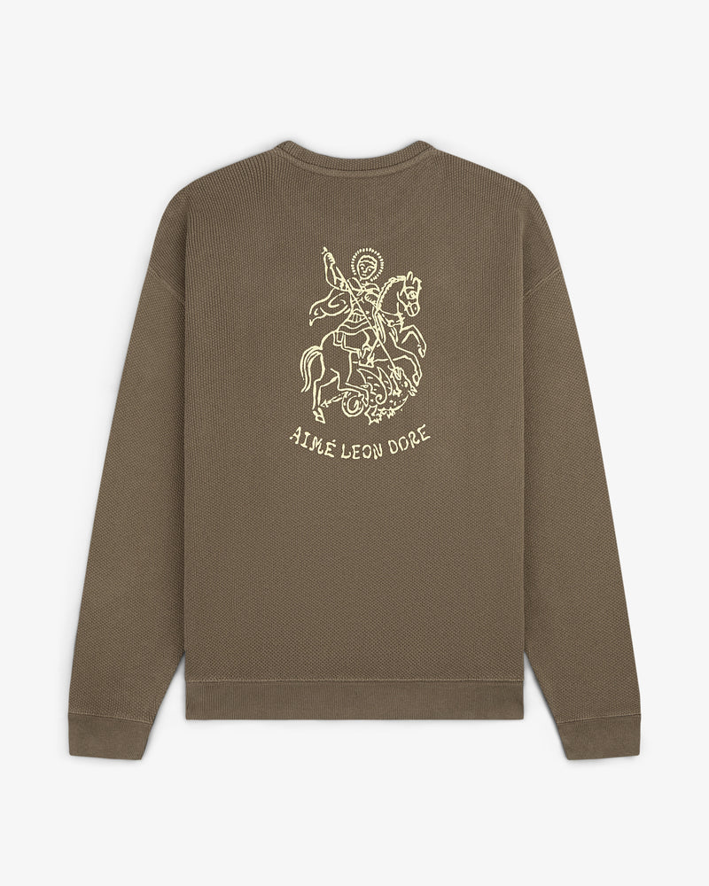 Olive green Saint George Piqué Crewneck with knight line drawing and AIMÉ LEON DORE text on the back.