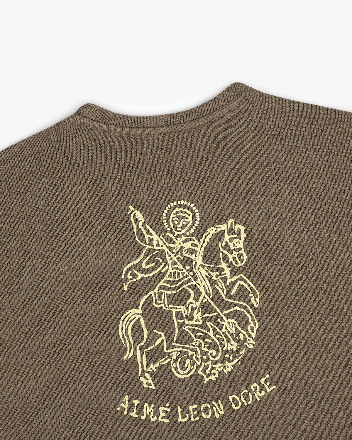 Brown Saint George Piqué Crewneck Sweatshirt with a yellow knight graphic and “AIMÉ LEON DORE” text below.