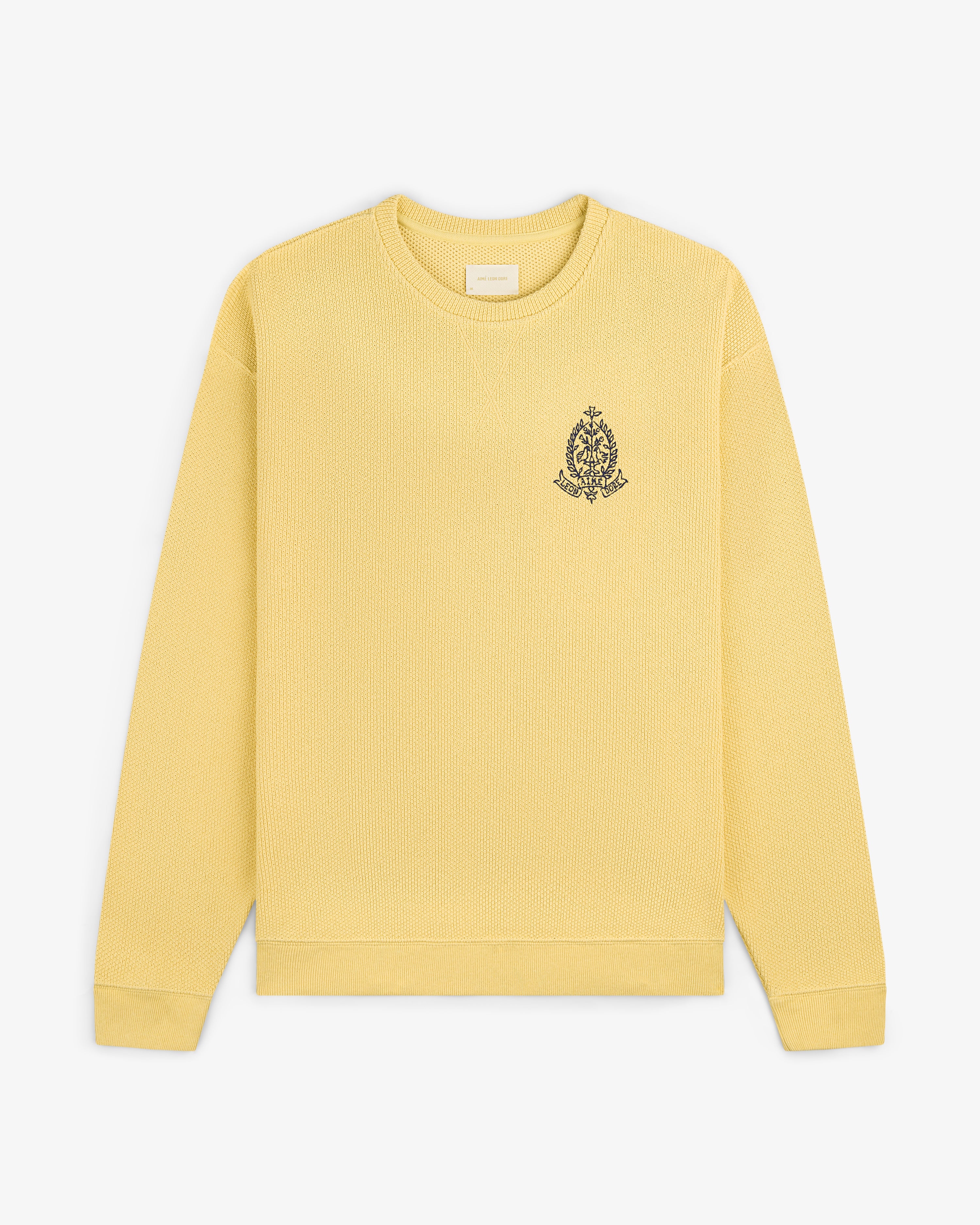 Saint George Piqué Crewneck Sweatshirt in yellow with small black crest on left chest, displayed on white background.