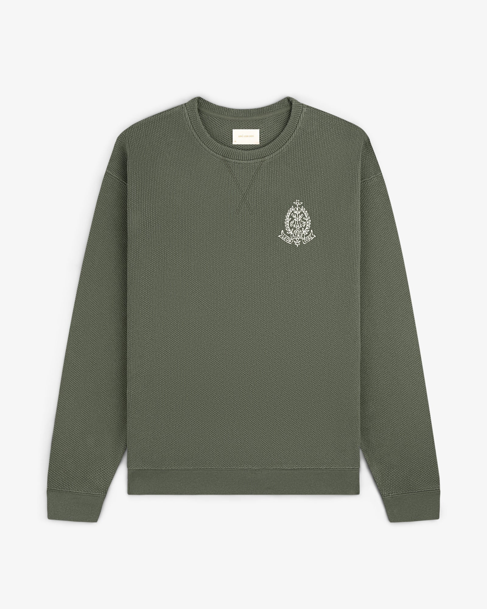 Saint George Piqué Crewneck Sweatshirt in olive green with a small white logo on the left chest, laid flat.