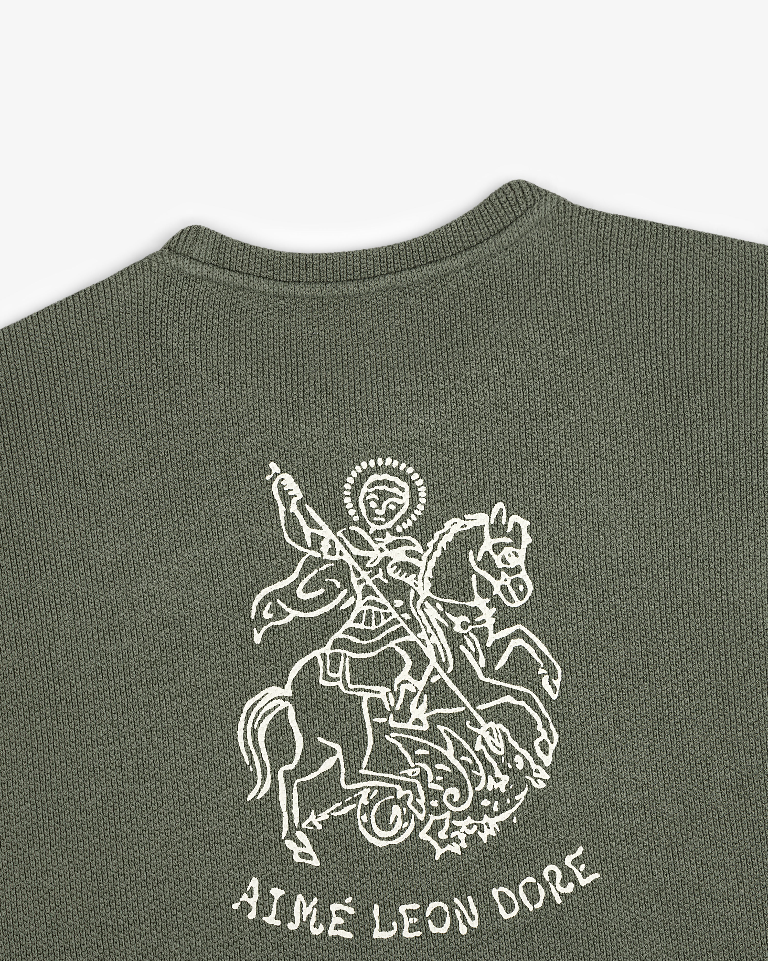 Green textured Saint George Piqué Crewneck Sweatshirt with a white knight graphic above AIMÉ LEON DORE text.