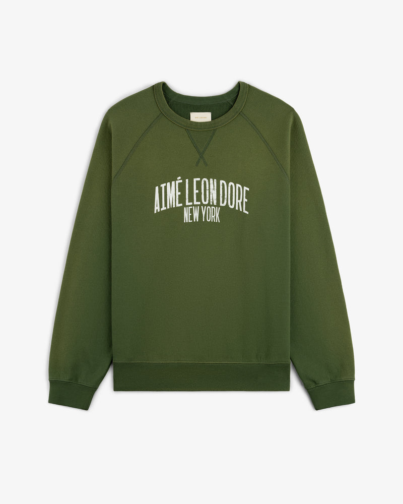 Vintage Washed Crewneck Sweatshirt in green with AIMÉ LEON DORE NEW YORK printed in white on the front.