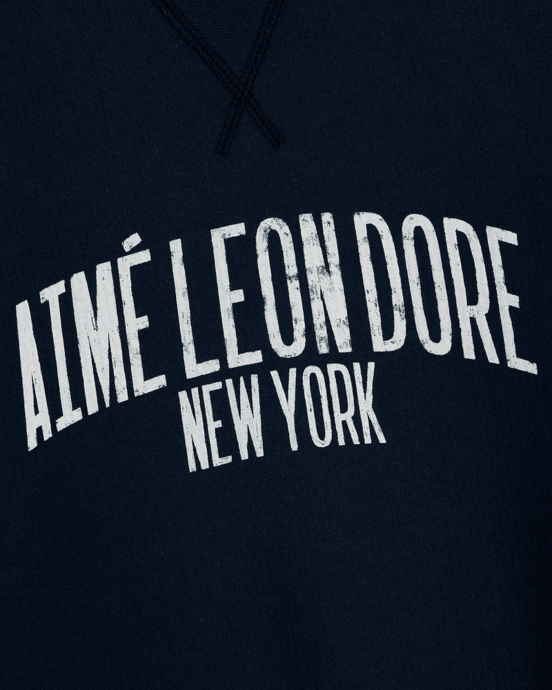 Navy Vintage Washed Crewneck Sweatshirt with white distressed 'AIMÉ LEON DORE NEW YORK' in bold arched letters.