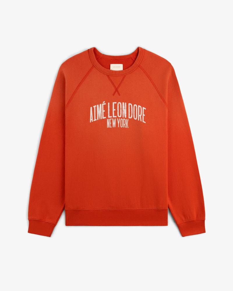 Vintage Washed Crewneck Sweatshirt in red with AIMÉ LEON DORE NEW YORK printed in white on the front.