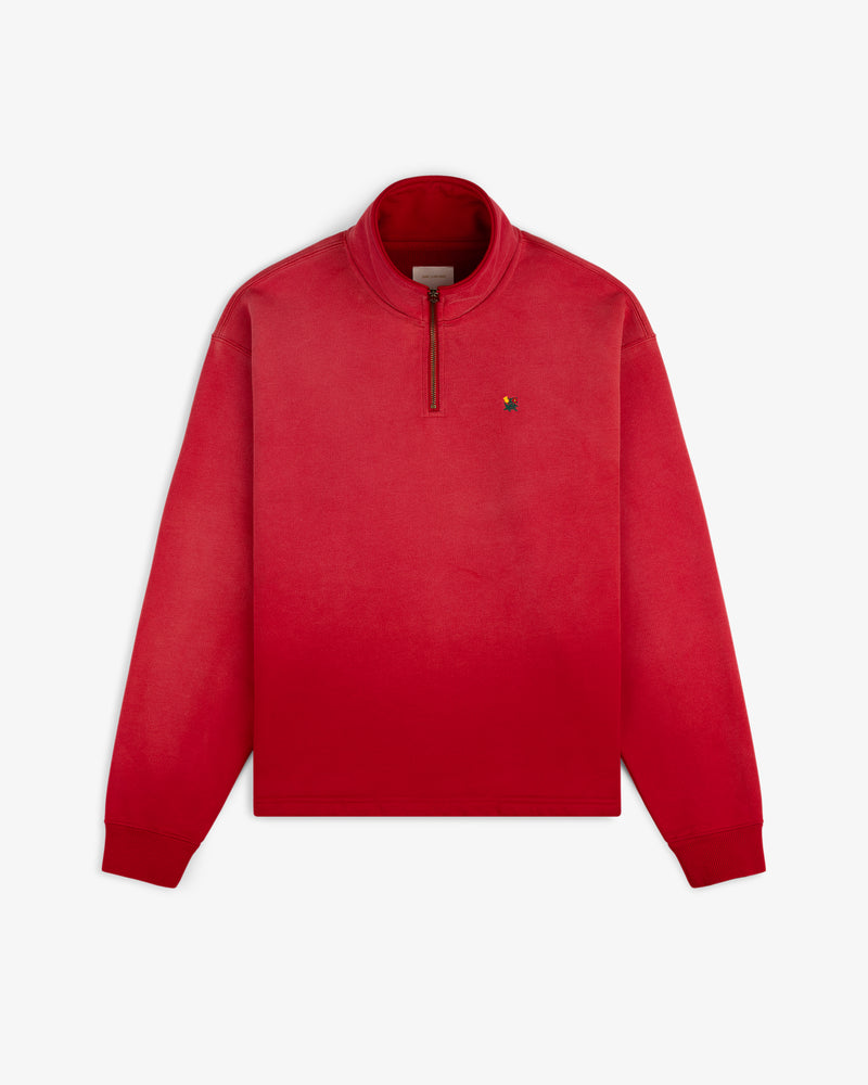 Sun Faded Crest Quarter Zip in red ombré with a small chest logo, shown flat on a white background.