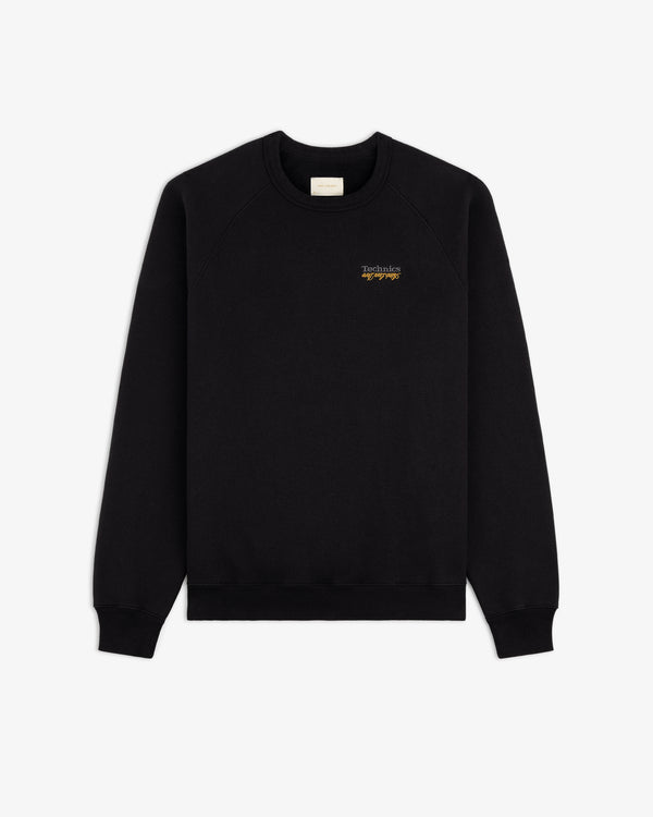ALD / Technics World Champions Crewneck in black with small yellow text on left chest, shown on white background.